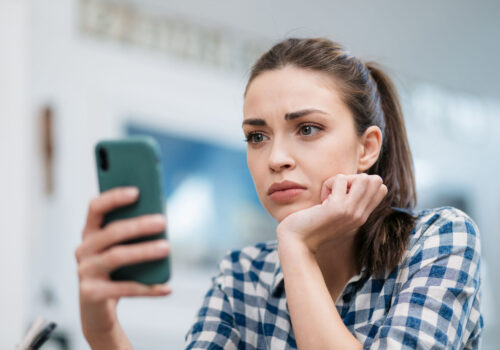 Close up of a depressed Caucasian young woman sitting at home