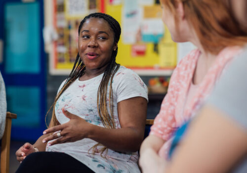 A side view of a women only pregnancy group where they can share their experiences of their pregnancy. They are all chatting together before they take part in a fitness class. They re in a community centre in the North East of England.